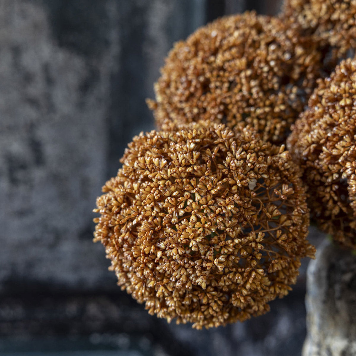 Close-up of realistic allium bulb with textured hand-painted fabric florets