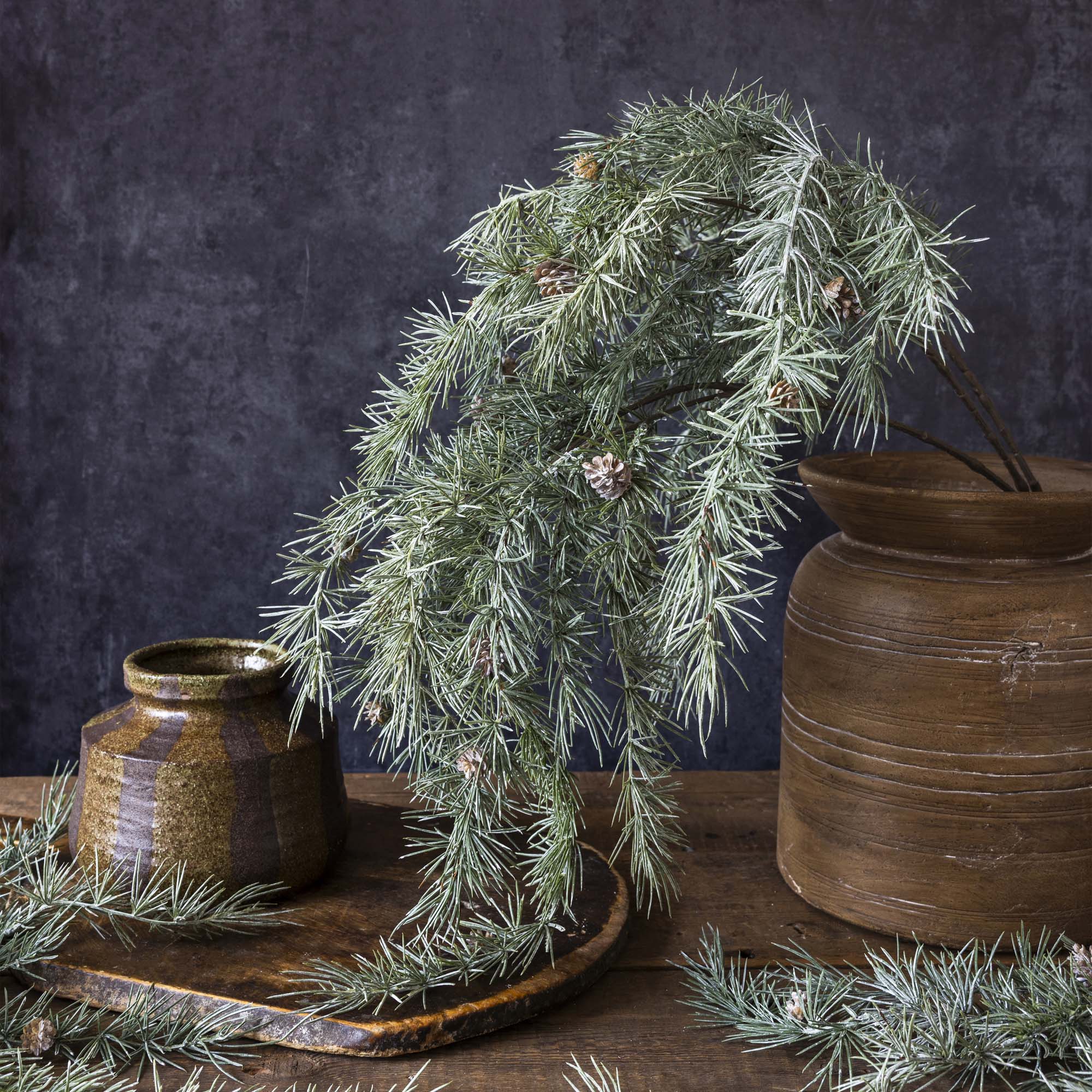 Forest-inspired greenery with faux pinecones and cedar foliage for winter decor
