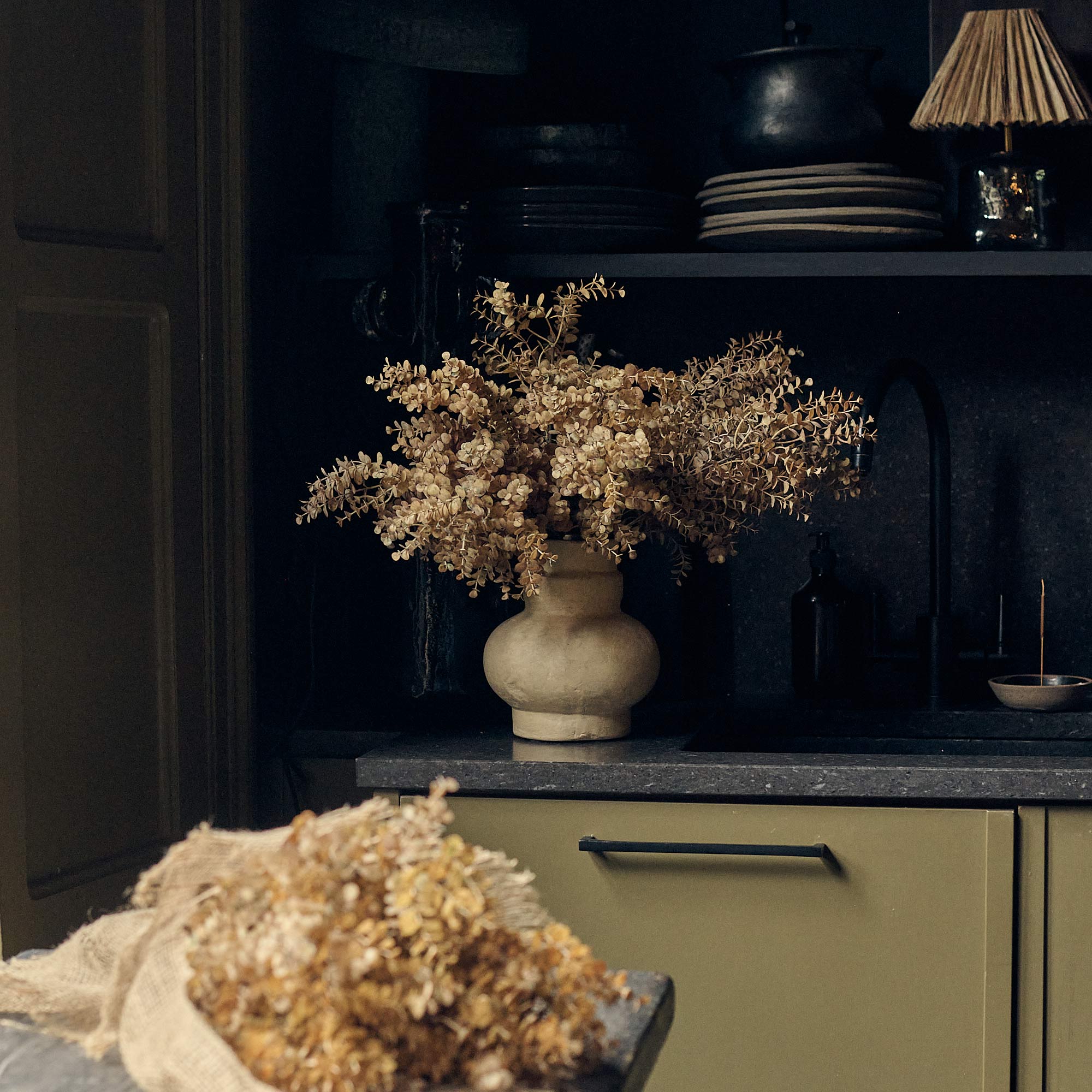 Artificial botanical bunch styled in minimalist interior with warm desert palette