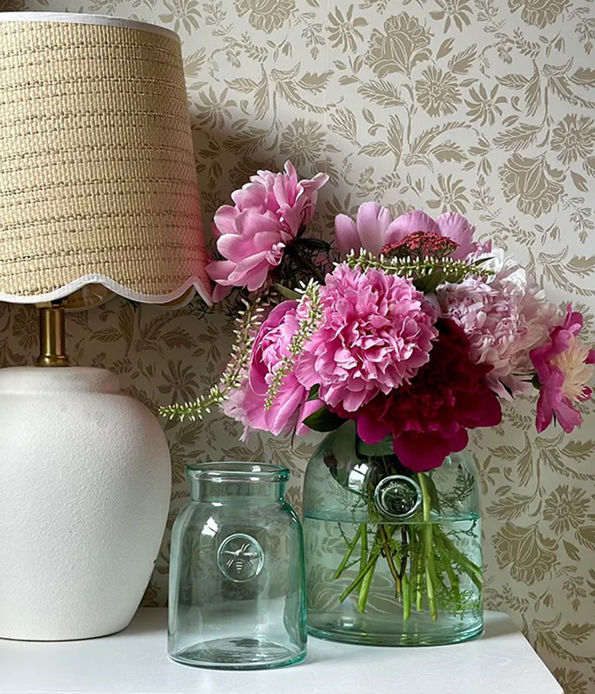 Handmade vintage-style glass vase with pressed bee emblem and subtle ripples