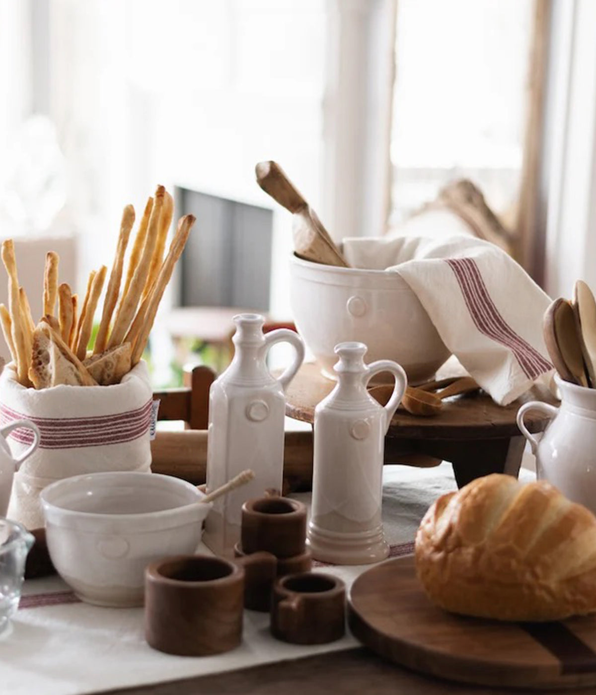 Glazed and raw handmade vinegar bottle placed on a rustic dining table