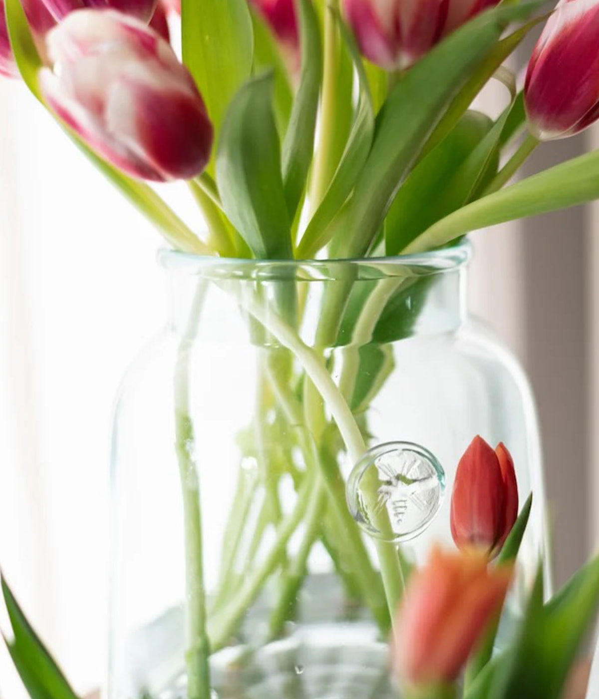 Food-safe recycled glass vase with sloped silhouette for flowers or kitchen use