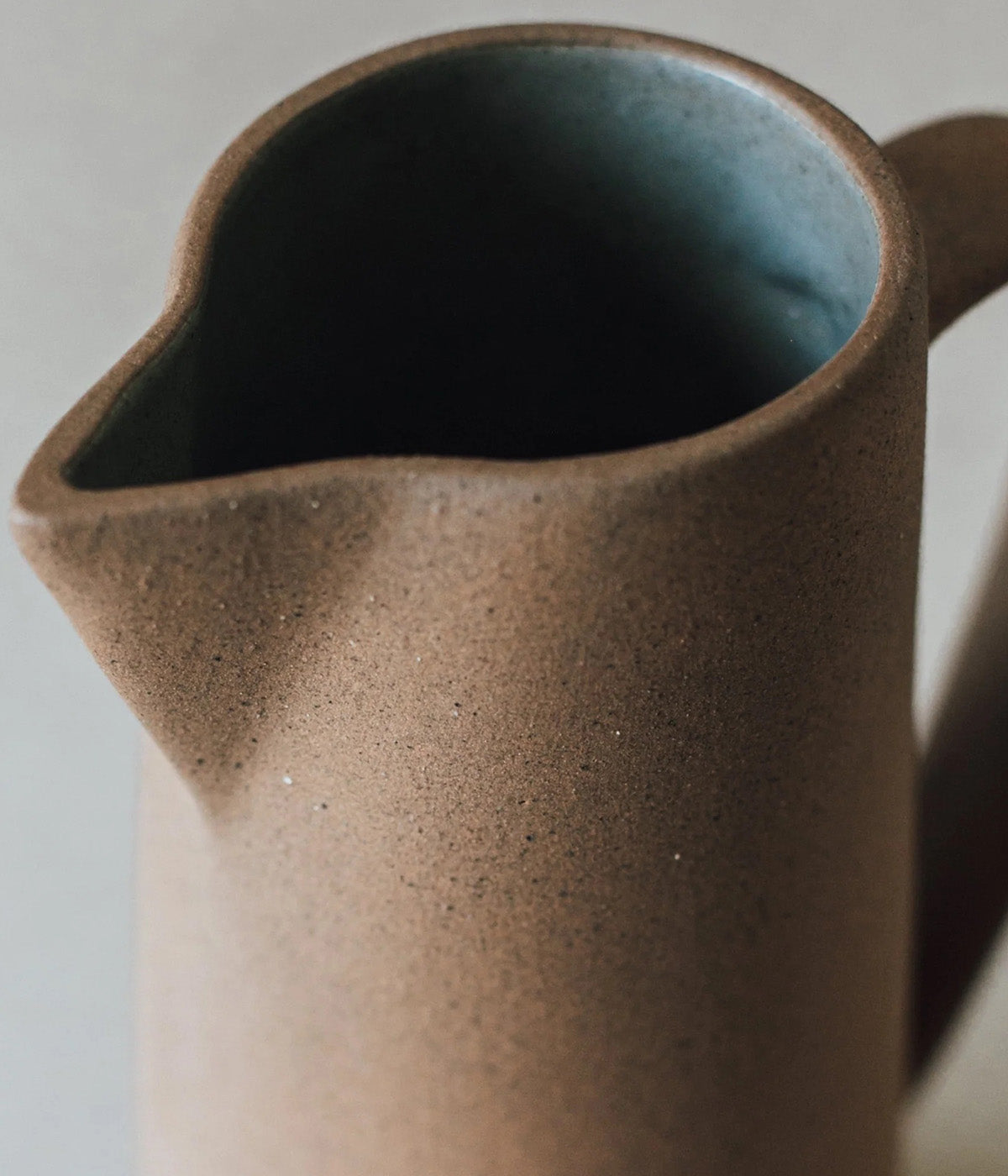 tall ceramic vase with smooth glazed interior and rustic exterior