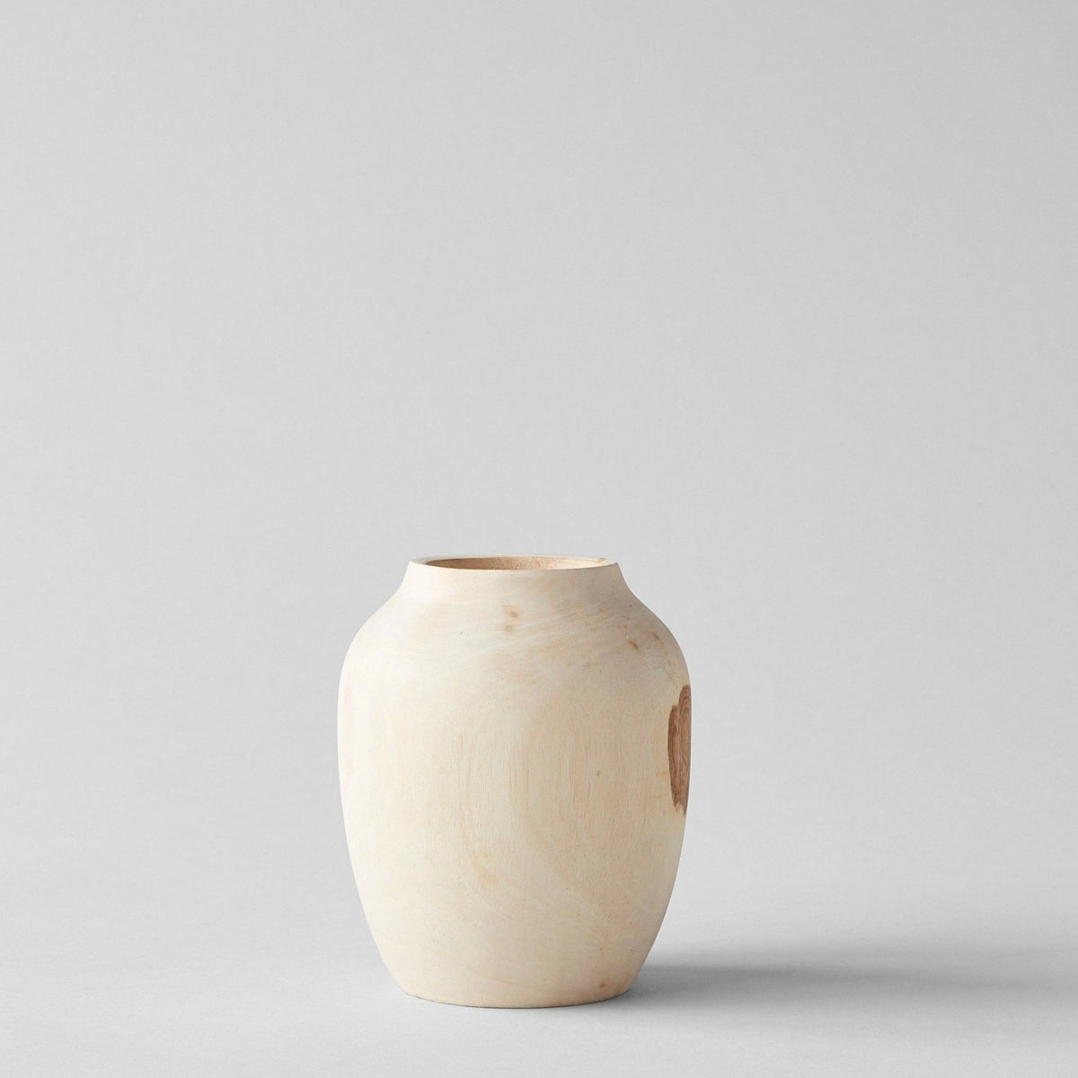 Hand-carved walnut wood vase with rounded plum shape