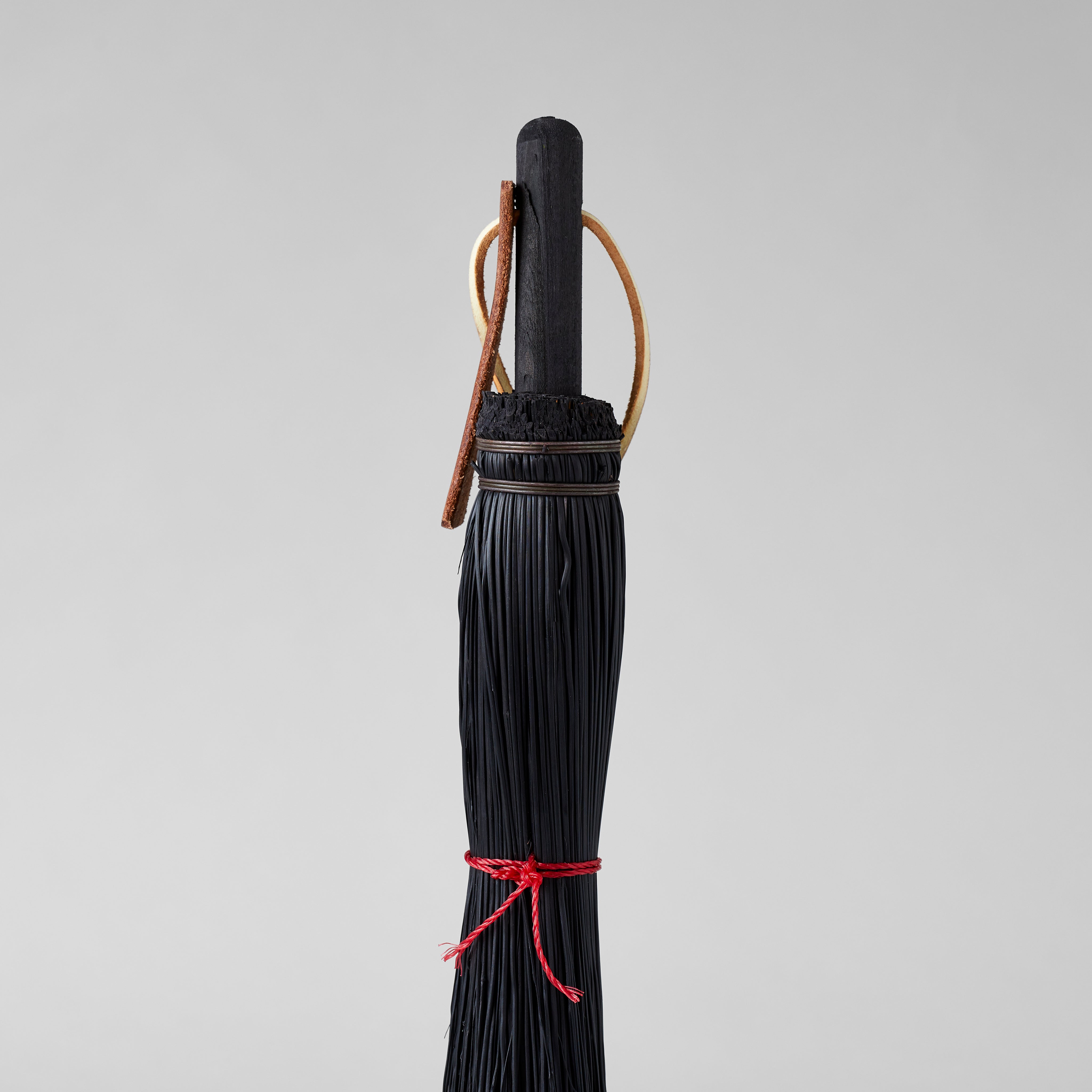 Handheld broom for cleaning fireplaces, desks, and potting areas