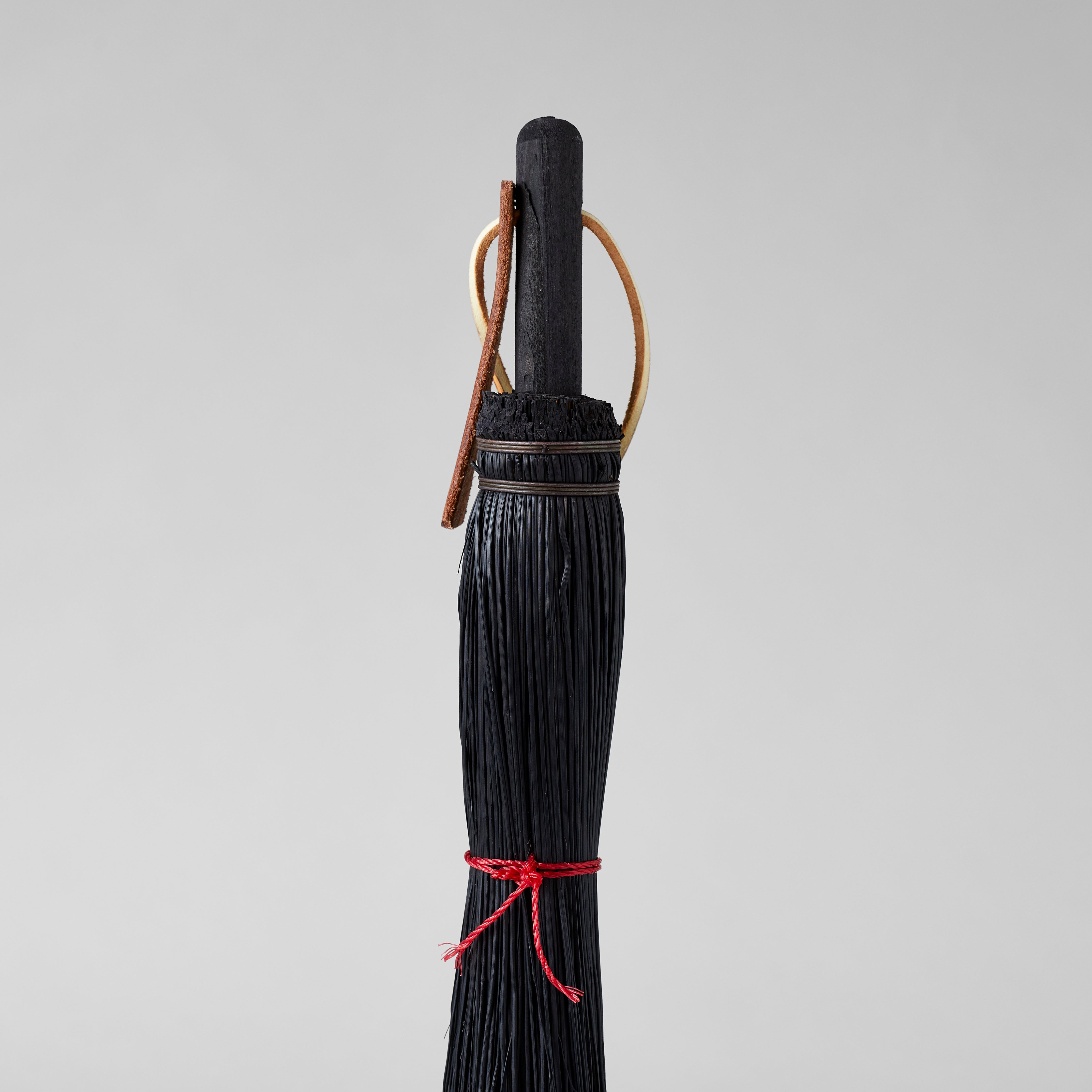 Handheld broom for cleaning fireplaces, desks, and potting areas