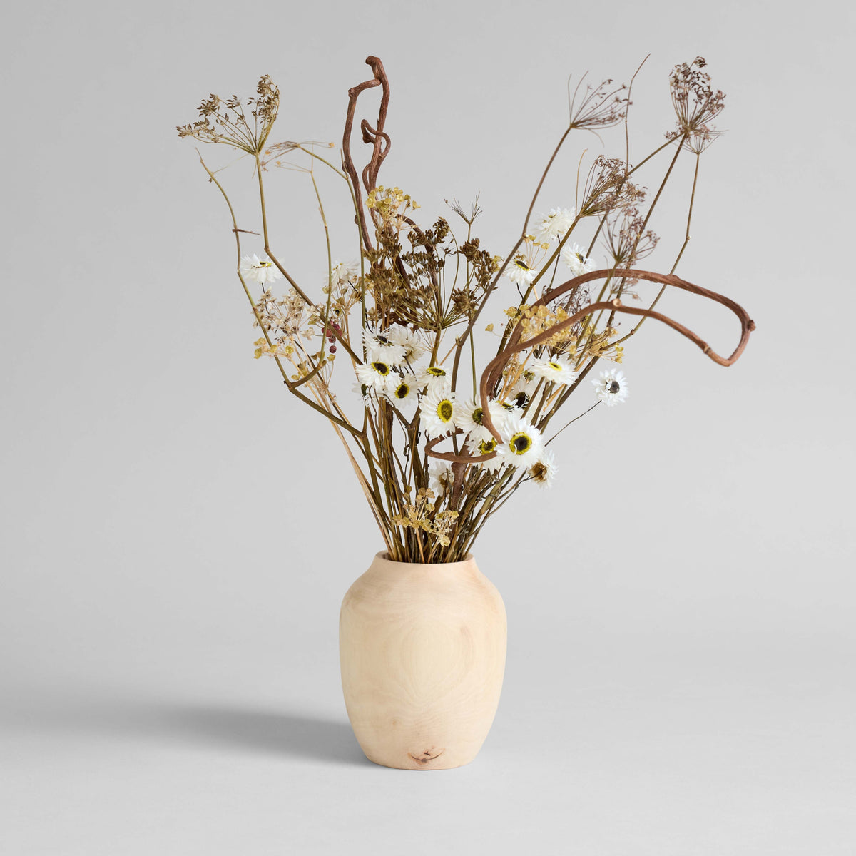 Handcrafted carved wood vase with natural grain and knots