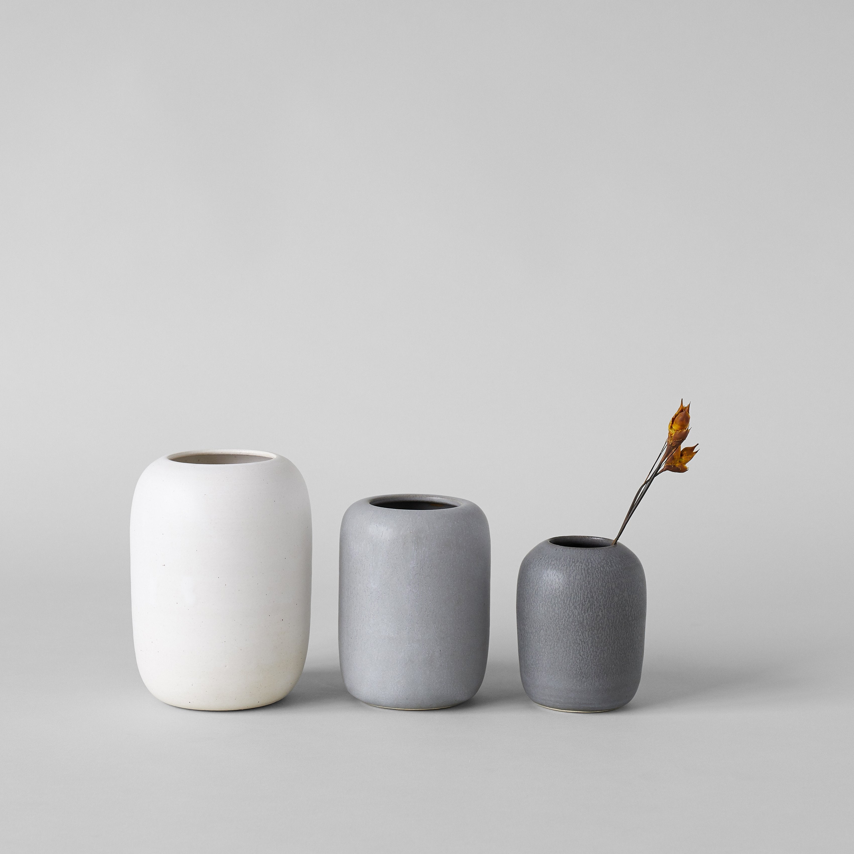 Textured handmade ceramic vases with glaze detail close-up