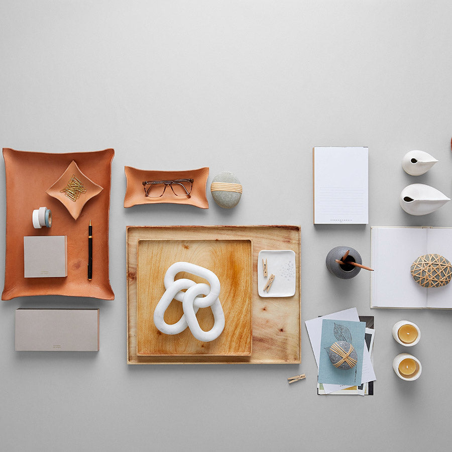 Crackled charcoal vase styled alongside sculptural objects
